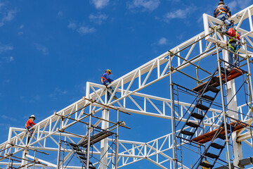 Architect on site construction roof workers on a scaffold