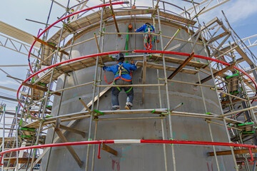 Architect on site construction roof workers on a scaffold