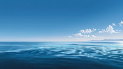 Obraz premium A serene view of calm blue ocean waters under a clear sky.