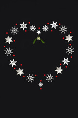 Christmas heart shape romantic wreath decoration, snowflakes stars mistletoe, red holly berries. Abstract festive design, symbol of love romance Xmas theme.