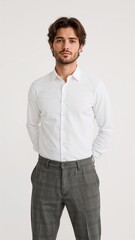 Full length of confident British man in a white polo and corduroy pants leaning slightly forward with hands in front pockets on plain white background