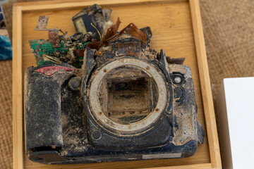 Old broken dusty DSLR camera body with corrosion