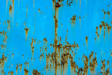 Rusty metal surface with blue paint and corrosion outdoors