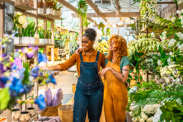 Garden center workers discussing plants and flowers arrangement