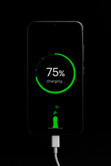 the smartphone is charging and the phone screen is charging, on a black background