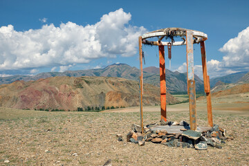 Religious wooden construction in Altai mountains.  In the background is visible Mount Sukor