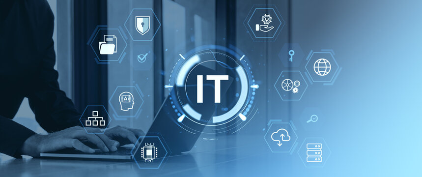 Businessman using laptop with IT icons and digital interface on blue background.