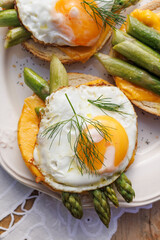 Vegetarian sandwich with fried egg and green asparagus, top view