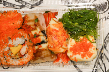 Sushi Cheap set Japanese street food with salmon raw fish and tobiko decoration.