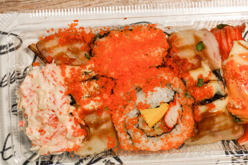 Sushi Cheap set Japanese street food with salmon raw fish and tobiko decoration.