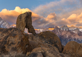 Boot Arch in the Alabama Hills With The Sierra Nevada Mountains During a Cloudy Sunrise. 