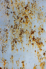 Weathered metal surface with rust and peeling paint outdoors