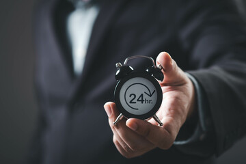 A businessman holds a clock showing 