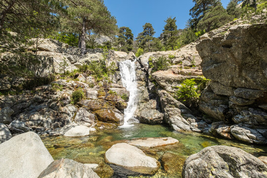 Water cascades over the Cascade des Anglais on the L'Agnone river through the forest and mountains of the GR20 trail at Vizzavona on the Mediterranean island of Corsica
