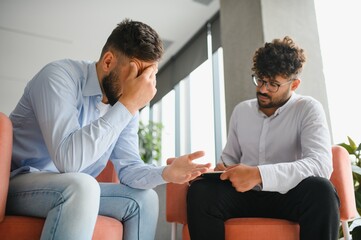 Psychologist listening to patient talking about problems during therapy session