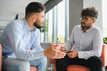 Psychotherapist listening to patient talking about problems during therapy session