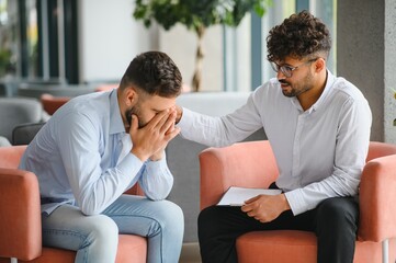 Psychologist comforting patient during therapy session