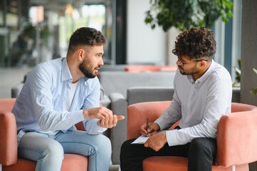 Psychologist listening to patient talking about problems during therapy session
