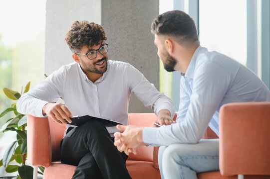 Psychotherapist listening to patient talking about problems during therapy session