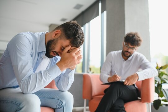 Psychologist listening to patient talking about problems during therapy session
