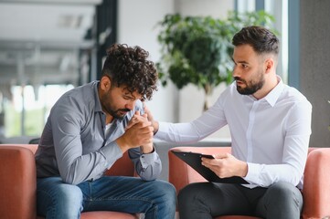 Psychologist comforting upset arab man during therapy session