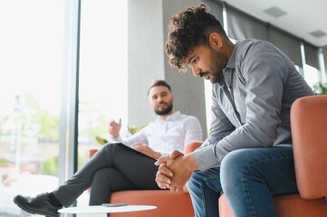 Fototapeta premium Upset arab man suffering from ptsd talking with psychologist