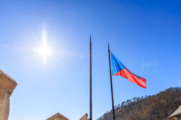 Fototapeta premium Czech national flag waving brightly on a clear sunny day