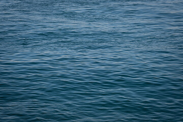 Naklejka premium blue water, sea surface background. small waves in the sea.