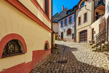 Charming european cobblestone street with colorful historic buildings
