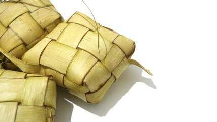 Traditional ketupat woven from young coconut leaves, commonly served during Eid al-Fitr and festive celebrations in Indonesia. Cultural food background.