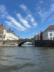 Historic stone bridge over canal with traditional buildings in Bruges, Belgium