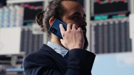 Expert businessman on a smartphone call discussing finance and analytics, building a corporate strategy. Surrounded by data charts, planning digital innovation and company growth. Camera A. - Powered by Adobe