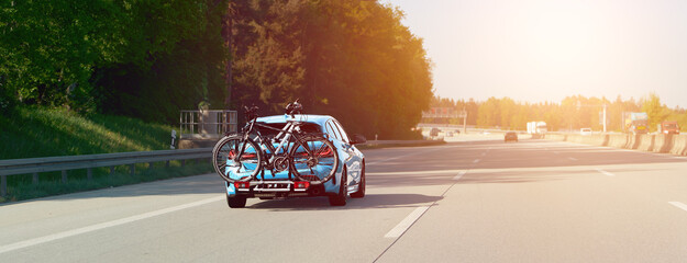 Sporty SUV carrying bicycles on open road