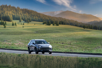 Fototapeta premium Electric Car Glides Down the Road in a Display of Modern Efficiency and Style