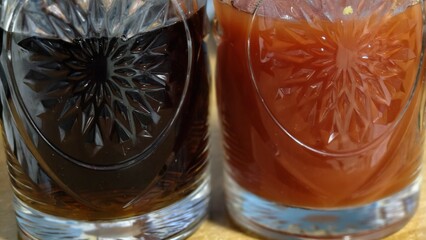 close-up of a glass of water and a glass of tomato juice