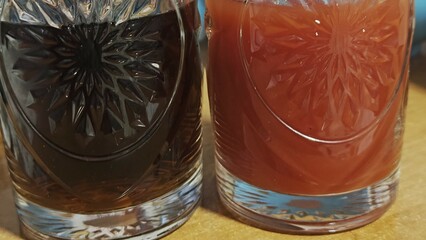 close-up of a glass of water and a glass of tomato juice