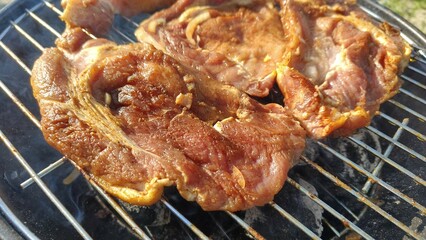 close up of grilled pork on charcoal grill