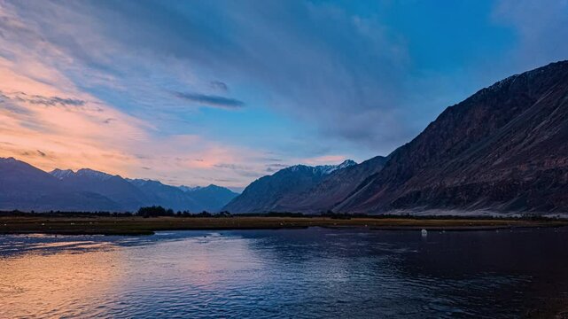 timelapse Nubra Valley, framed by the Karakoram Range, holds fertile ground with apples, apricots, and barley. The Shyok Rivers flow past arid lands rich in seabuckthorn and stark mountain beauty.