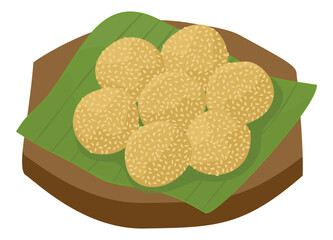 A set of onde onde, Indonesian traditional food, round sesame seed-covered glutinous rice balls, sits on a wooden board with banana leaves.