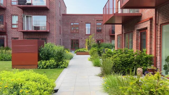 Herning, Denmark - June 12, 2025: Modern architecture apartments in Denmark summer days. Modern block of flats. A large building with a courtyard in the middle. Danish architecture design. Houses 