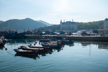 Fototapeta premium Peaceful Harbor with Boats at Sunrise