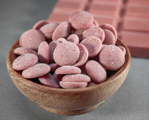 Chocolate chips for melting, pink chocolate in small pieces, sweets straight from the confectionery shop