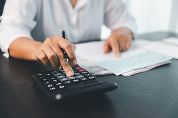 Using calculating machine, household carefully manages each bill and expense to plan financial budget, ensuring timely payment, consistent saving, smart investment for secure home finance strategy.