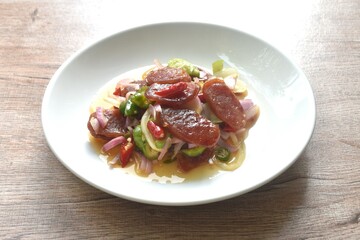 spicy and sour sweet slice Chinese pork sausage with vegetable salad on plate  