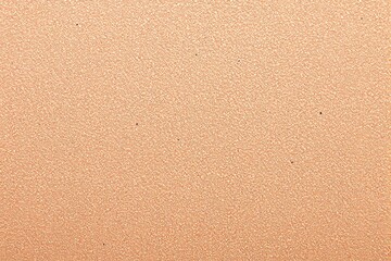 Textured beige stucco wall background with rough surface.
