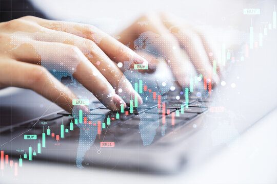 Female hands typing on laptop keyboard with forex candlestick chart, world map overlay, and buy-sell indicators on light background.