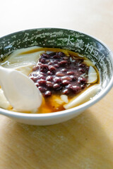 A sizzling, golden-brown pork cutlet freshly fried at a lively night market. The crispy coating and juicy meat inside make it a popular Taiwanese street food, tempting visitors with its aroma and irre