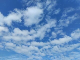 Expansive Blue Sky with Fluffy White Clouds