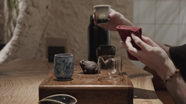 A meaningful act in a Chinese tea ceremony as the tea master honors tradition by pouring brewed tea over a small clay frog.