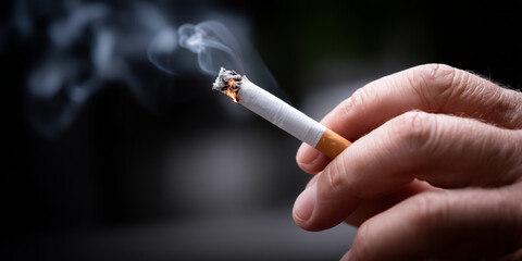 Close-Up of Hand Extinguishing Cigarette with Rising Smoke